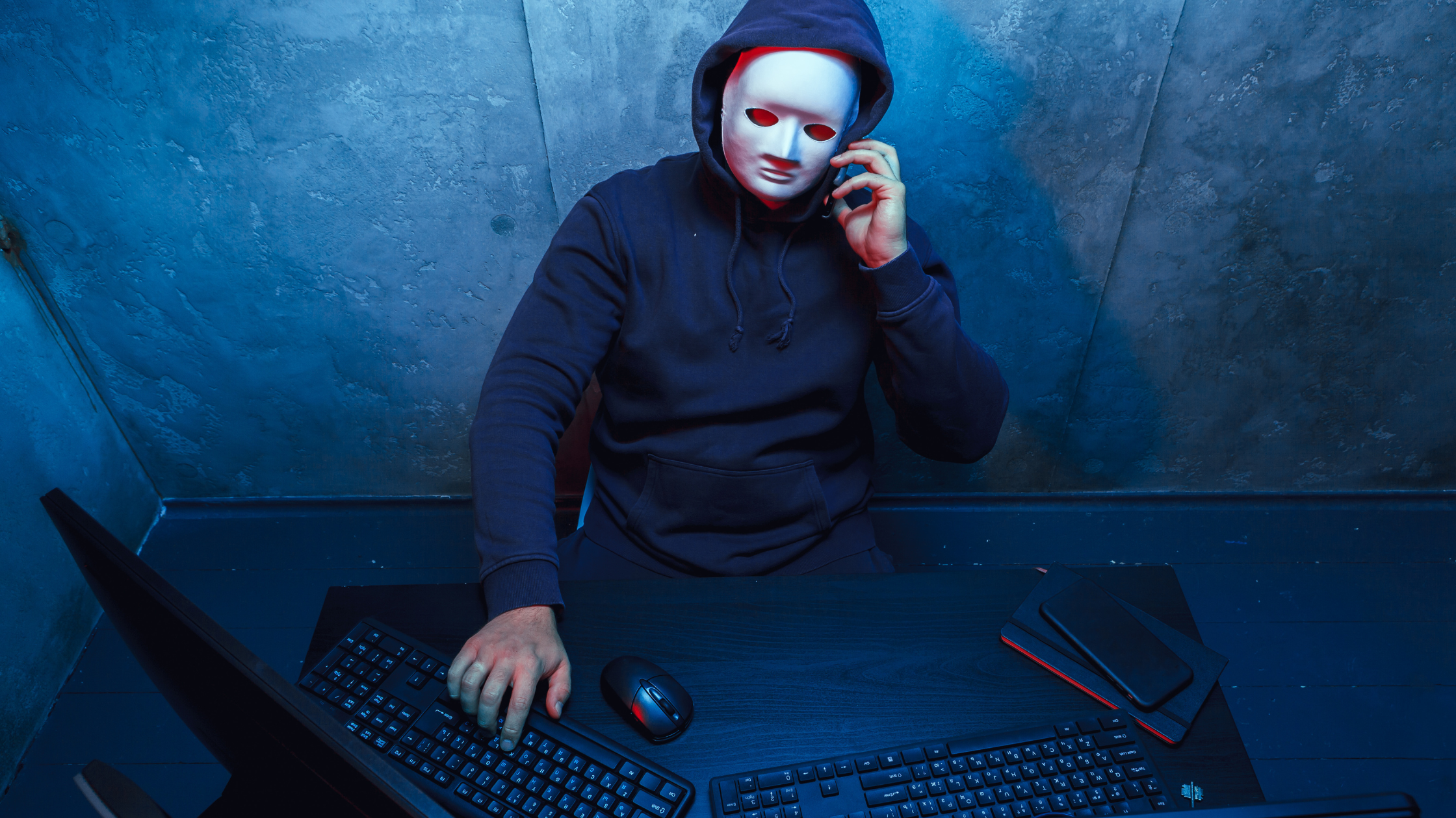 masked man on a phone