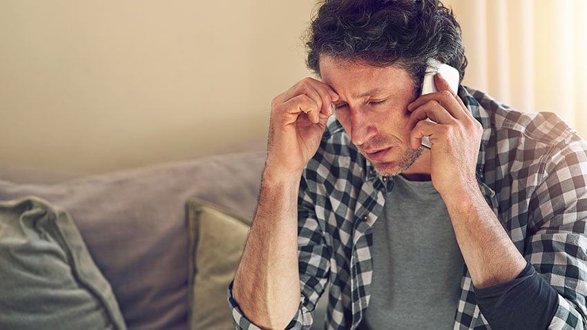 Man Answering a Fraudulent Phone Call