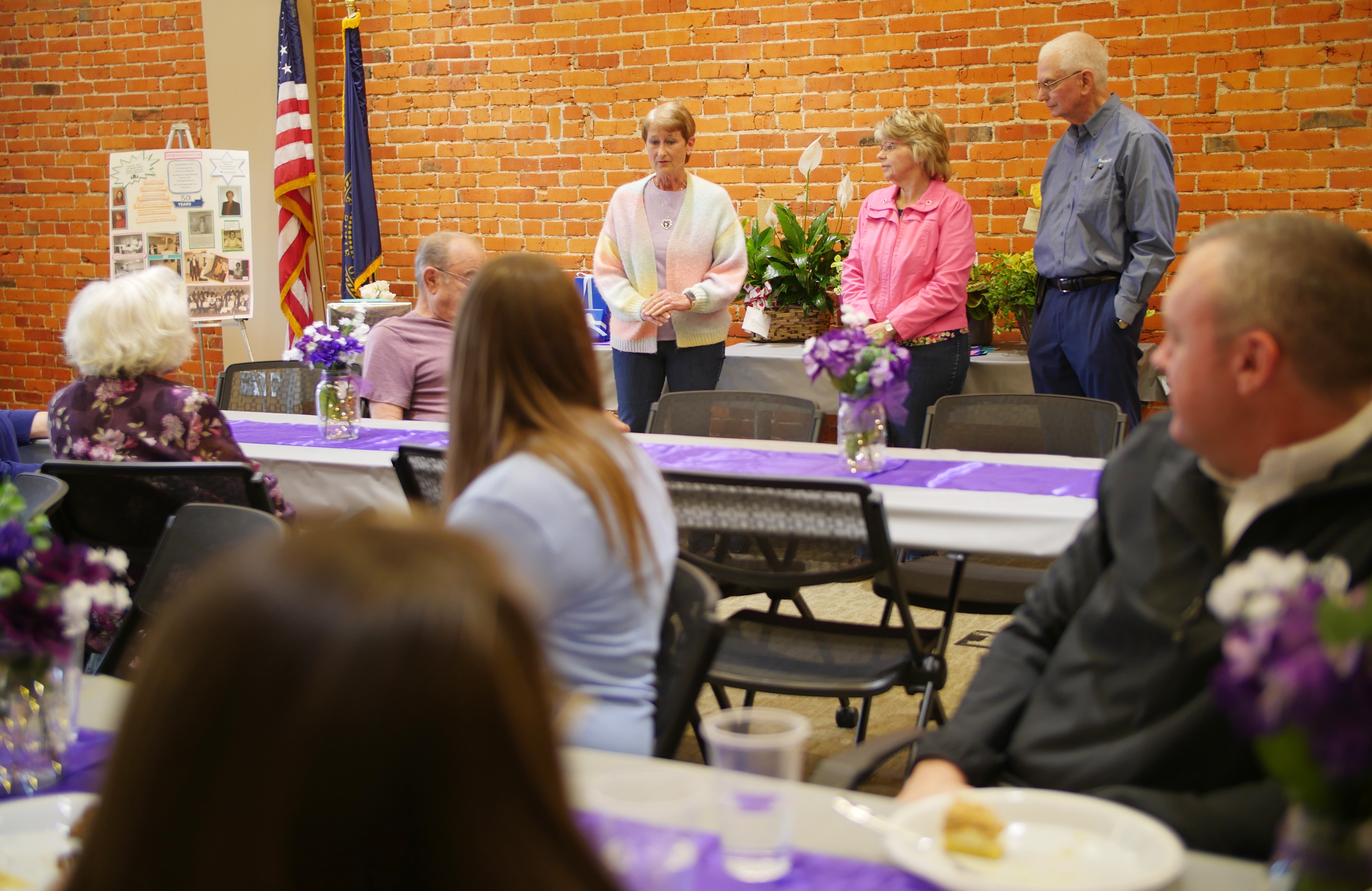 Lila speaking at her anniversary celebration about her early years with the bank.