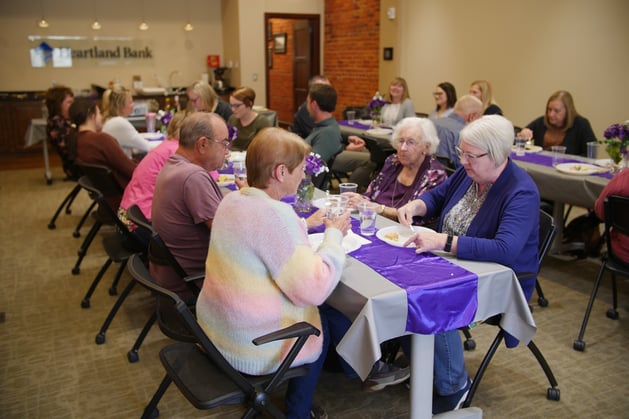 Heartland Bank employees sitting at tables eating
