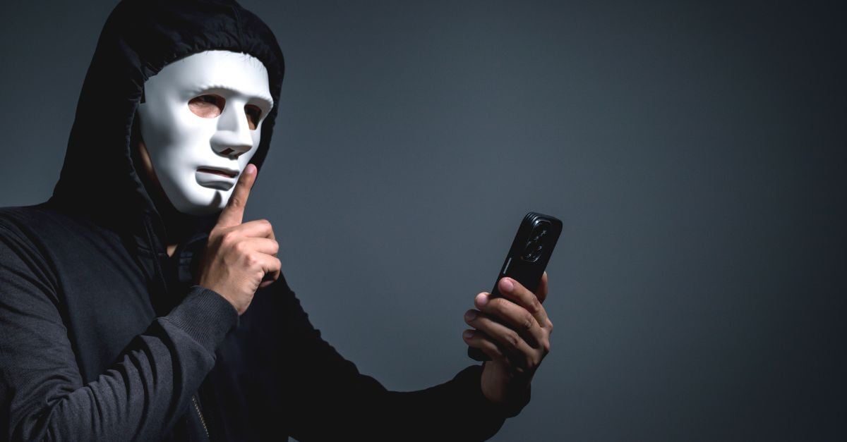 person on phone wearing mask