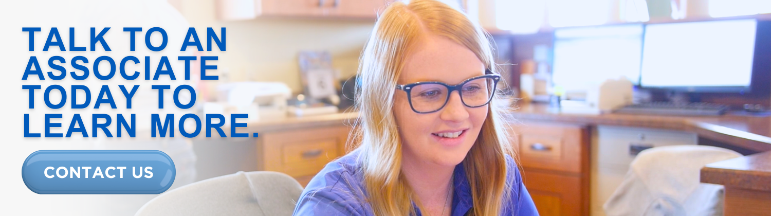 Talk to an associate today to learn more. A Heartland Bank associate smiling and ready to help you when you need us.